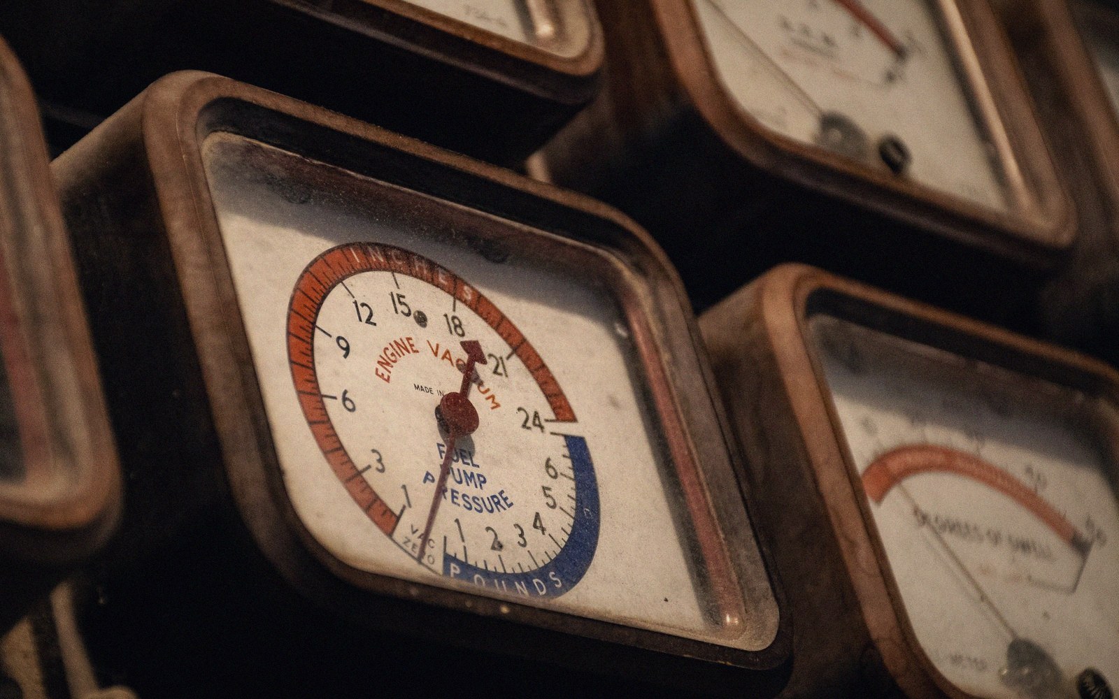 A vintage analogue Geiger counter with a large dial on a concrete surface